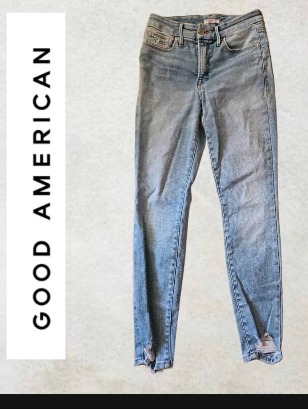 Good American light-wash skinny jeans featuring a frayed, distressed hem detail